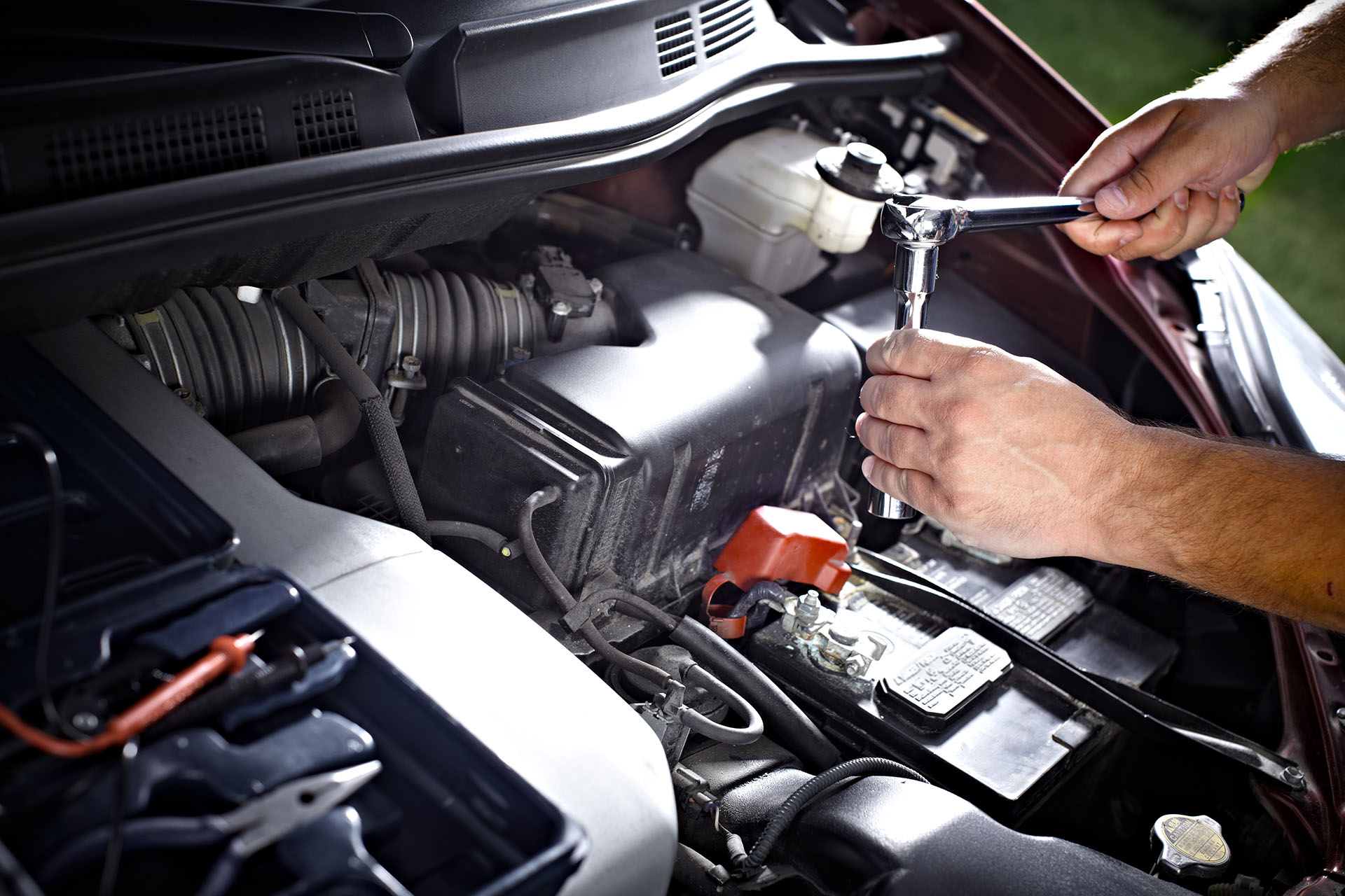 Auto mechanic working in garage. Repair service.